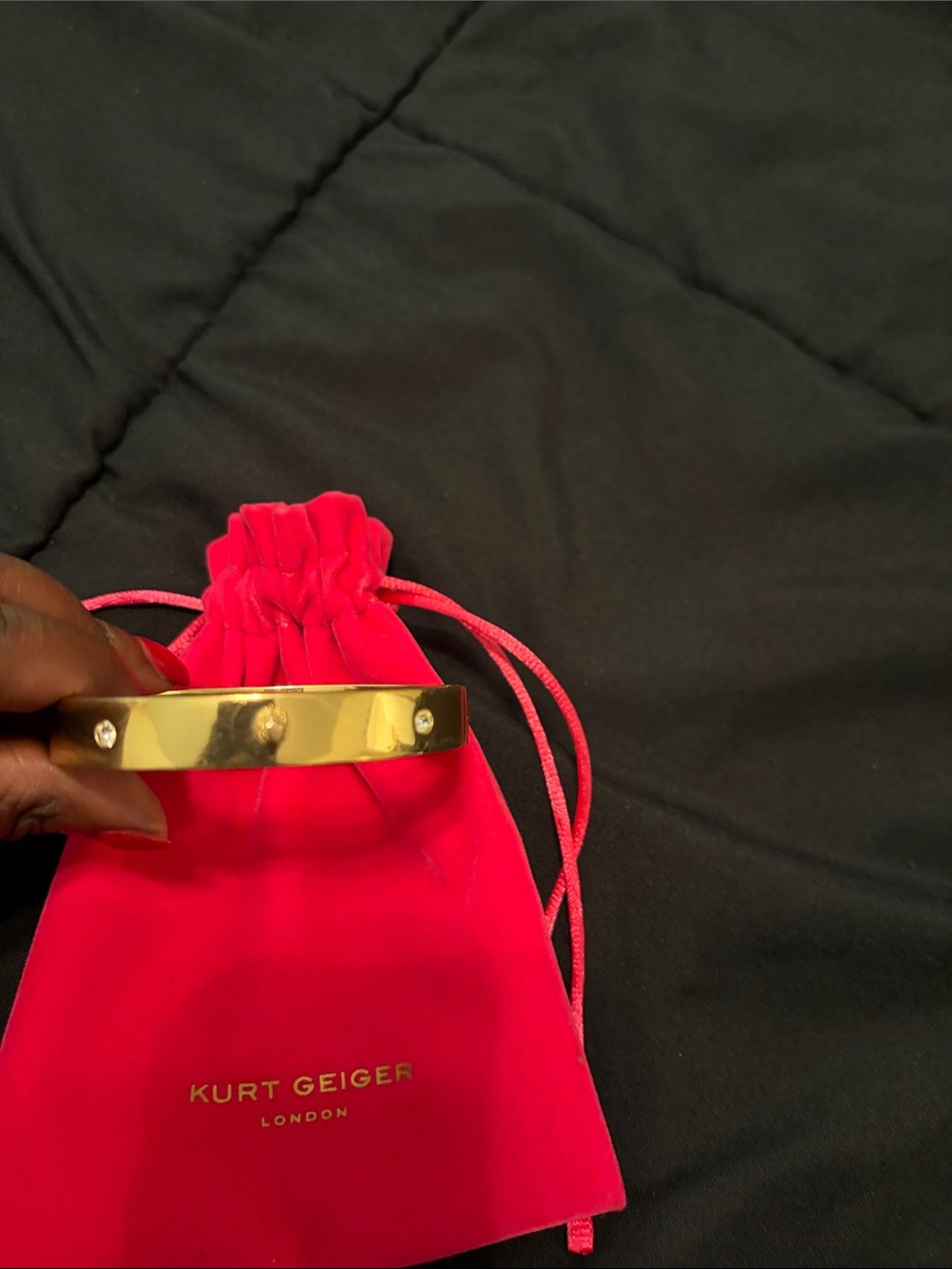 Kurt Geiger Gold Tone Bangle with Pink Drawstring Pouch